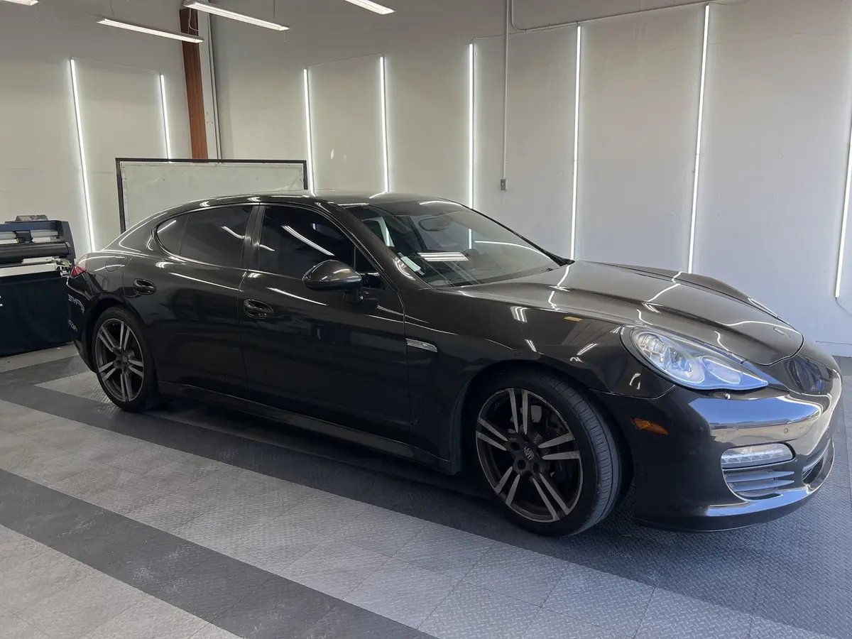 Black Porsche Panamera before window tinting, factory glass (view 3)