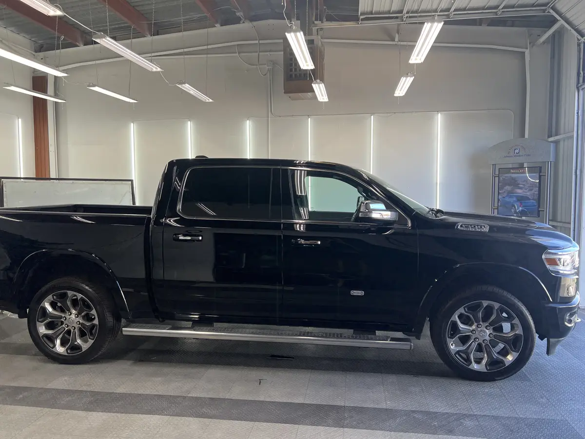 Black Ram 1500 before window tinting, factory glass (view 1)