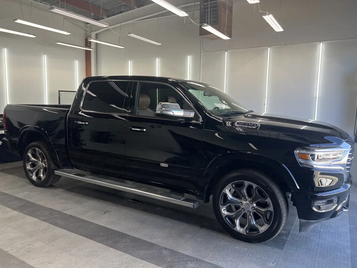 Black Ram 1500 before window tinting, factory glass (view 2)