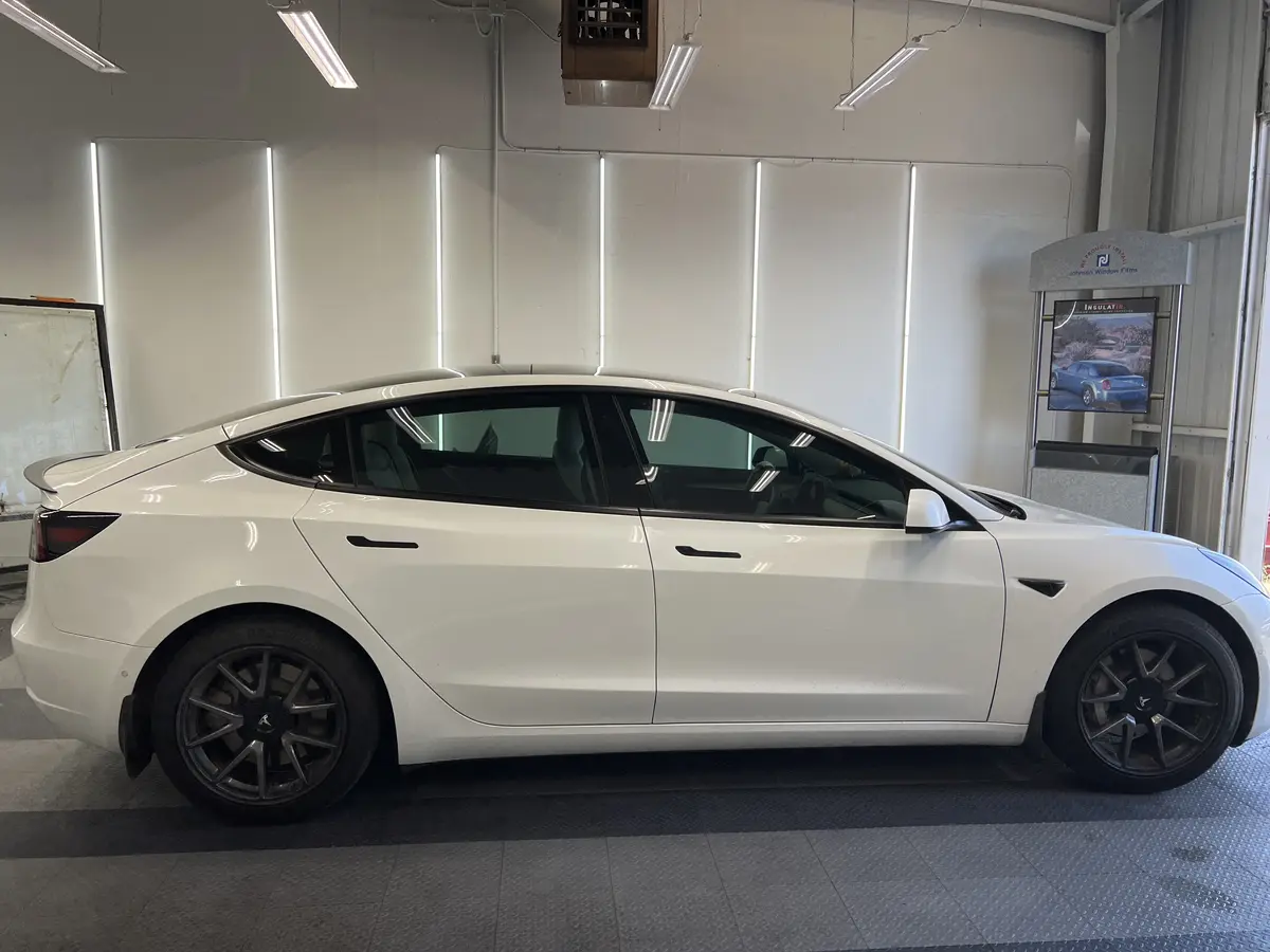 White Tesla Model 3 before window tinting, factory glass (view 2)