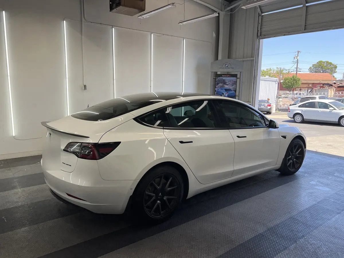 White Tesla Model 3 before window tinting, factory glass (view 3)