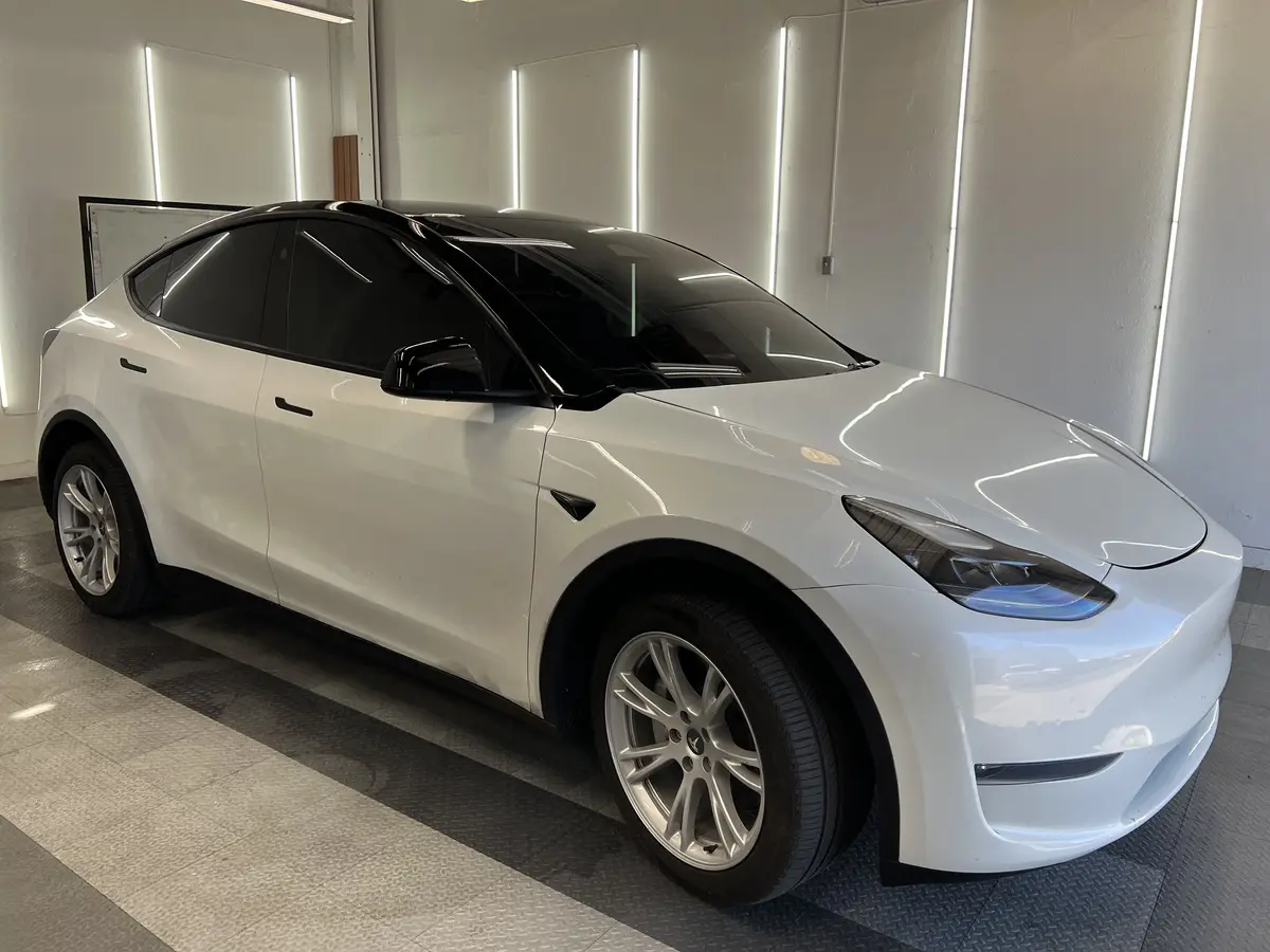 White Tesla Model Y after Avery Dennison Encore Supreme ceramic window tint (view 1)