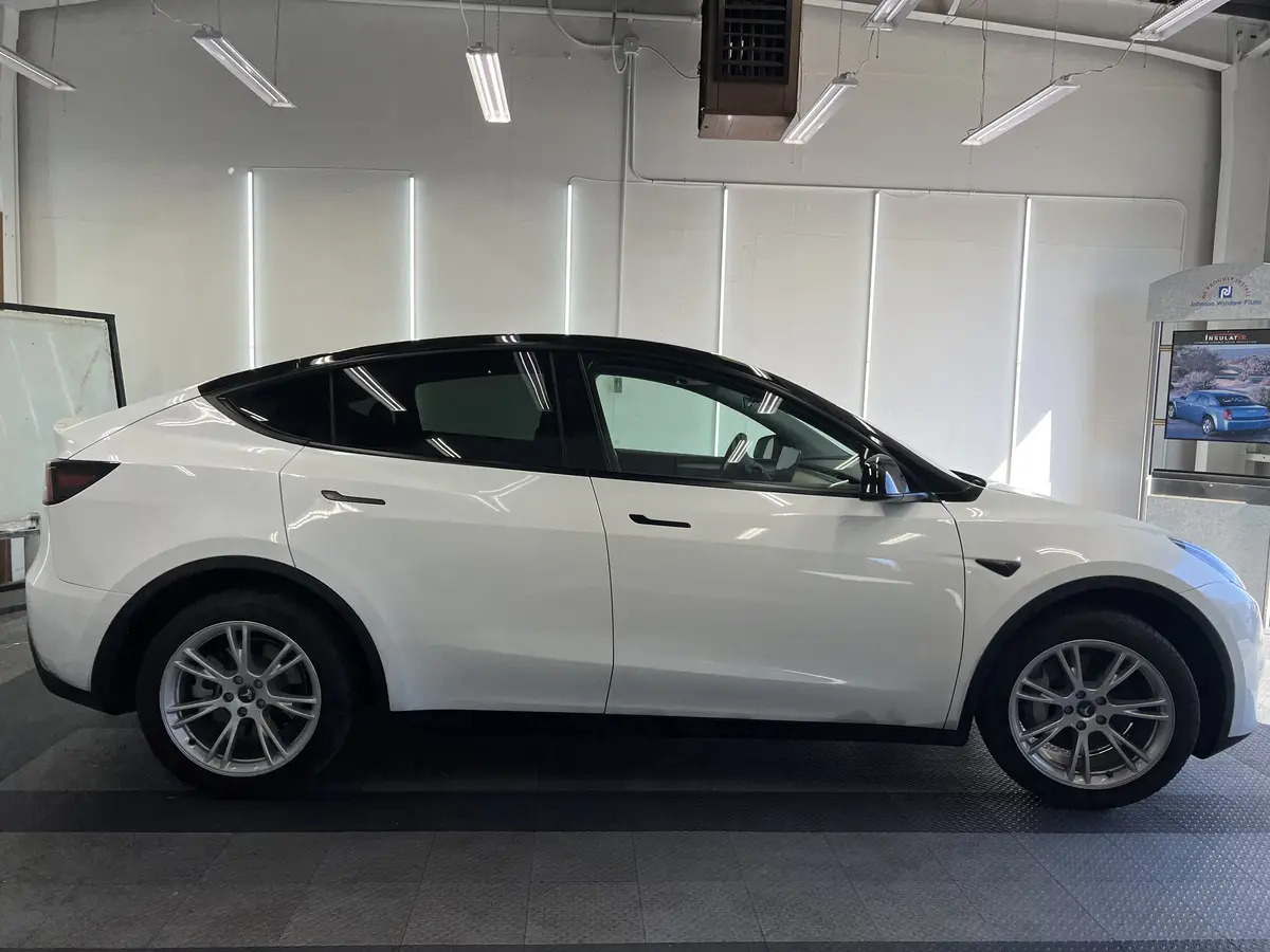 White Tesla Model Y before window tinting, factory glass (view 2)