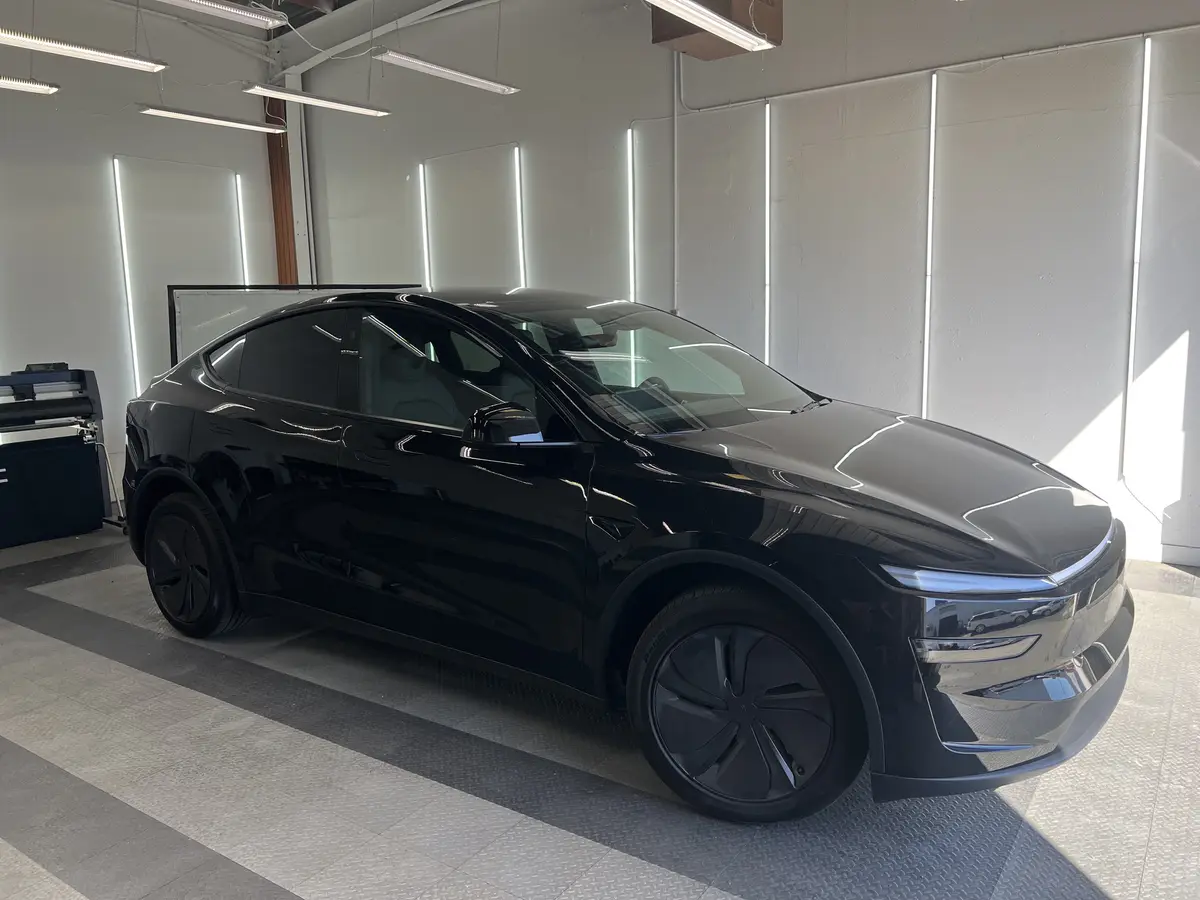 Black Tesla Model Y before window tinting, factory glass (view 1)