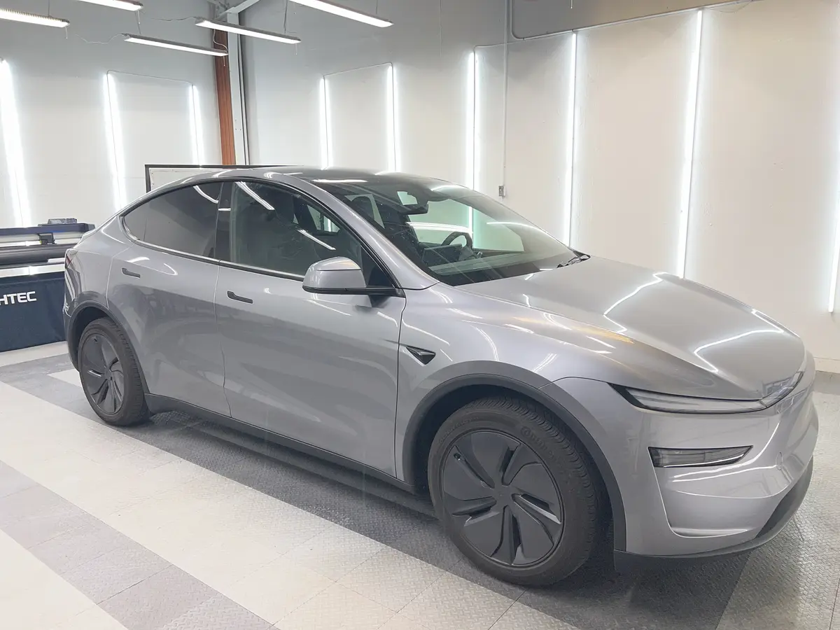 Silver Tesla Model Y before window tinting, factory glass (view 1)