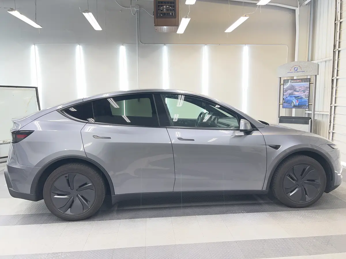 Silver Tesla Model Y before window tinting, factory glass (view 2)