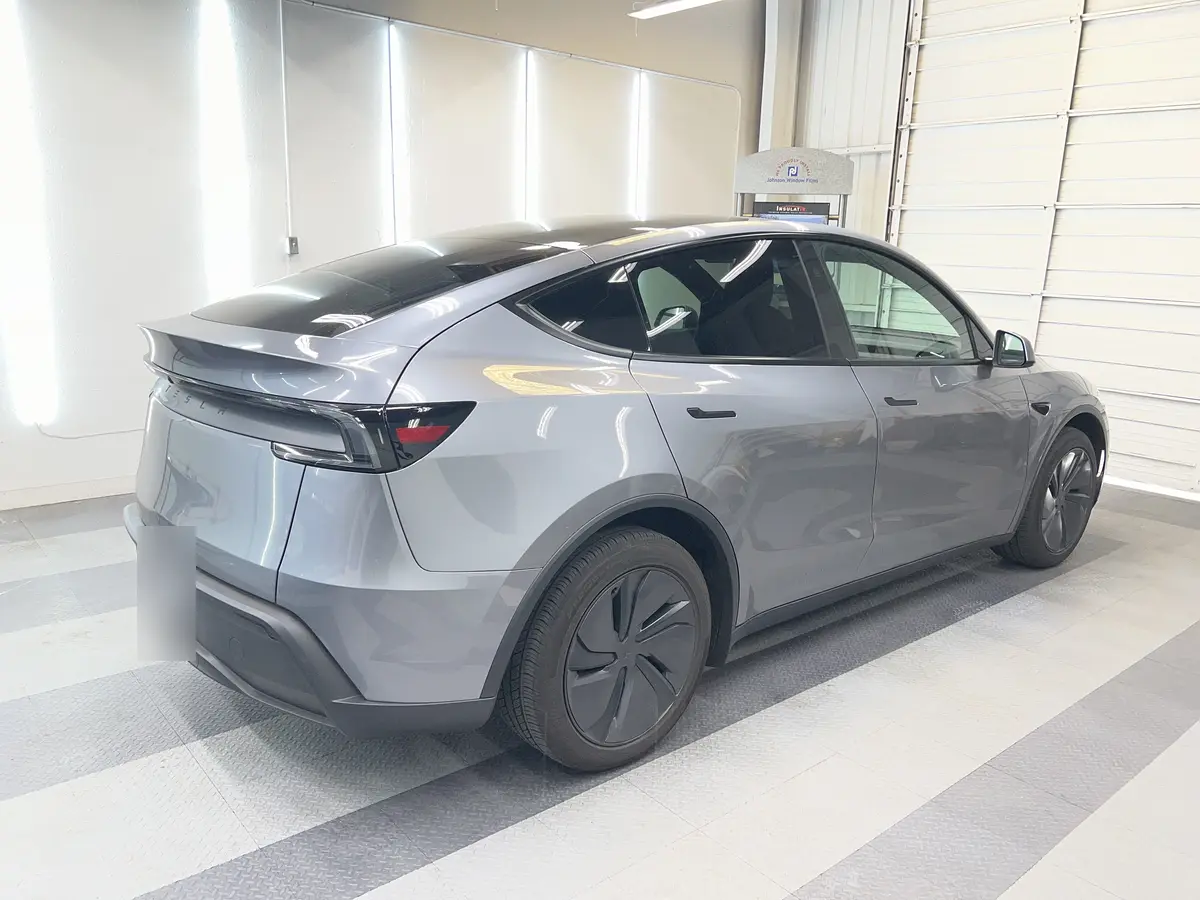 Silver Tesla Model Y before window tinting, factory glass (view 3)