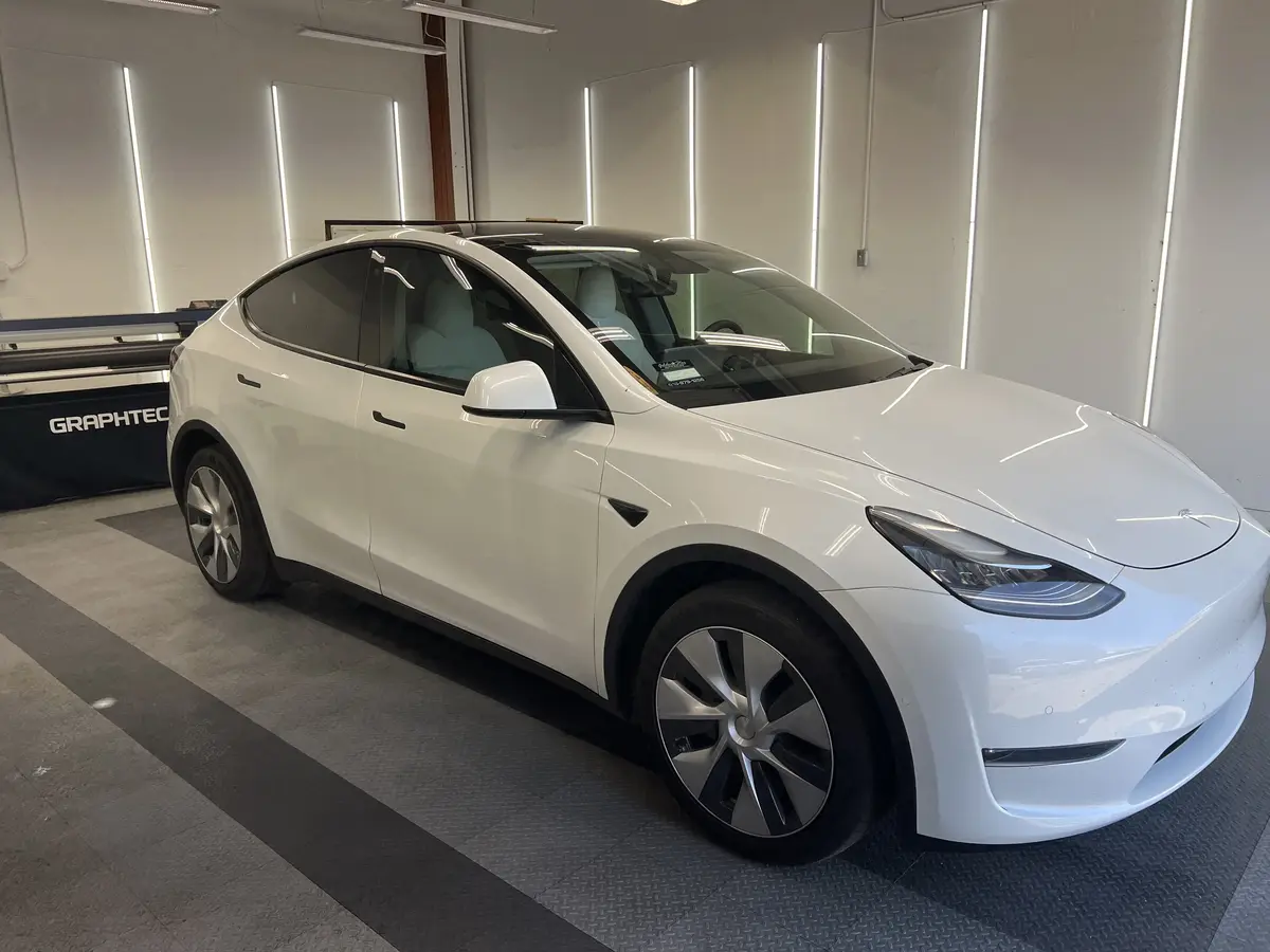 White Tesla Model Y after Avery Dennison Encore Supreme ceramic window tint (view 1)