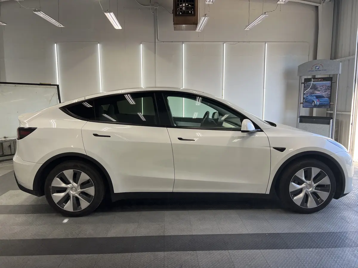 White Tesla Model Y before window tinting, factory glass (view 2)