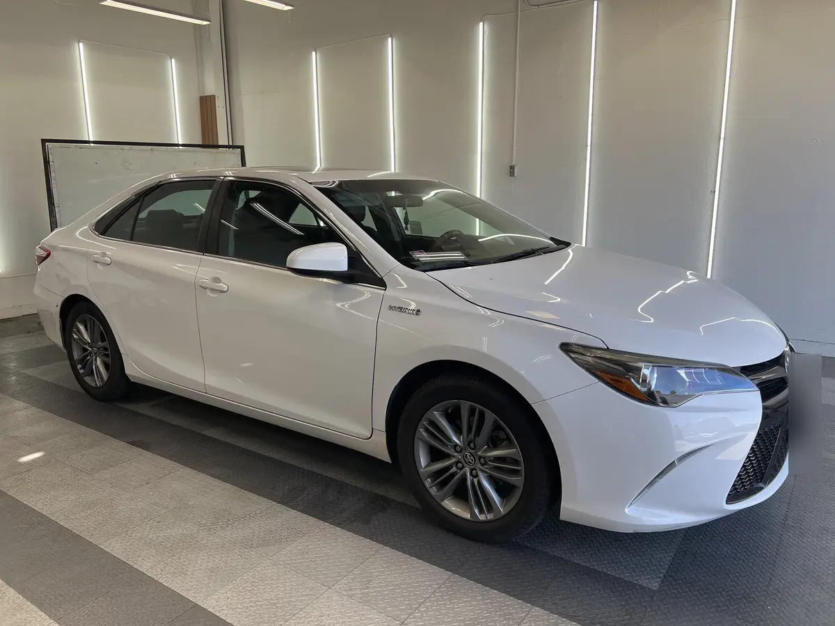 White Toyota Camry before window tinting, factory glass (view 1)