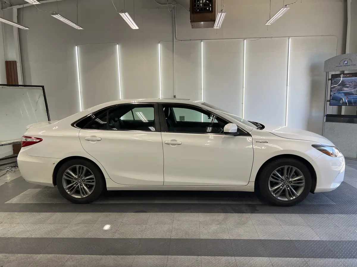 White Toyota Camry before window tinting, factory glass (view 3)