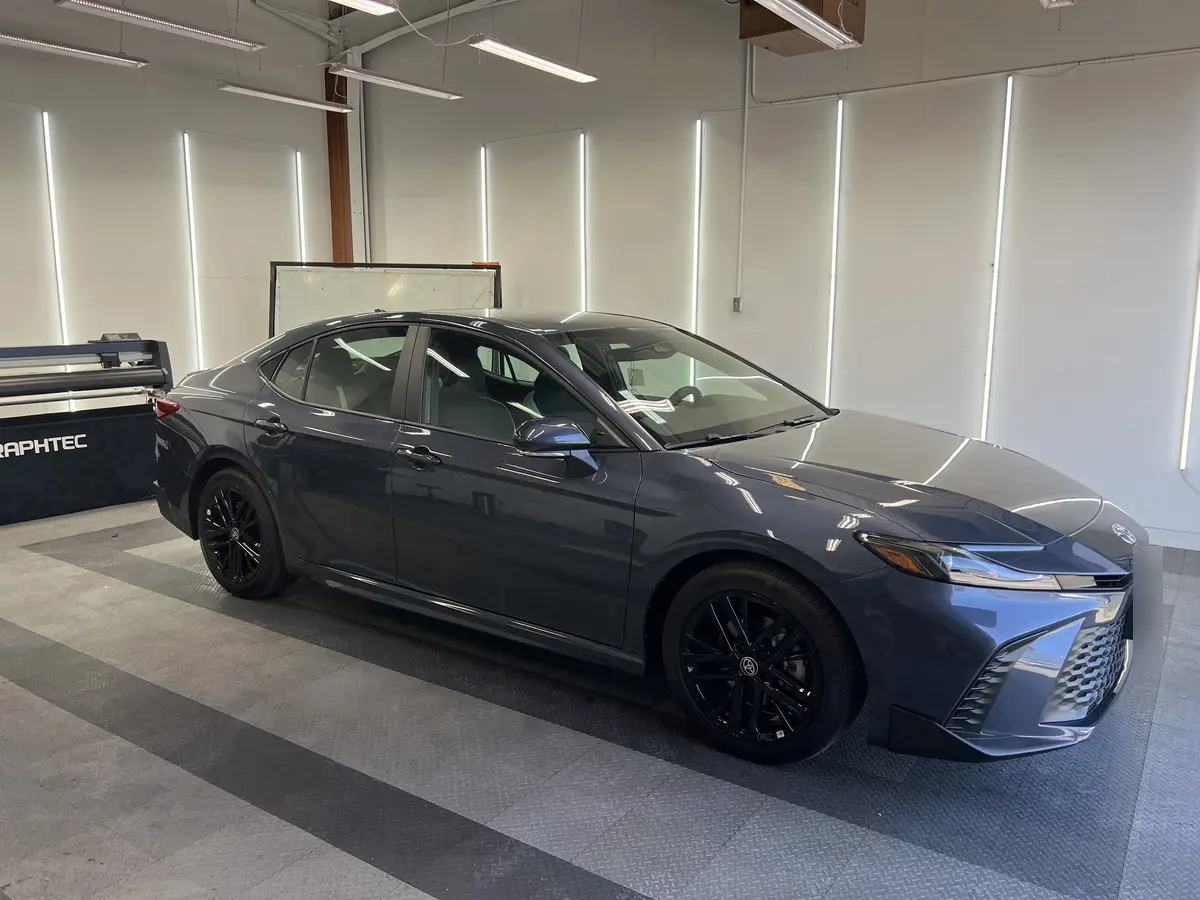 Gray Toyota Camry before window tinting, factory glass (view 1)