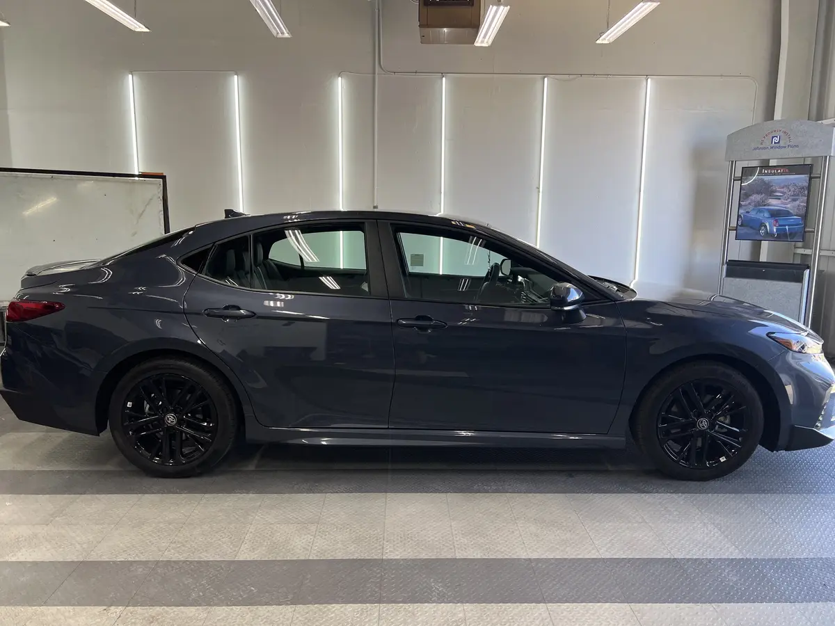 Gray Toyota Camry before window tinting, factory glass (view 2)