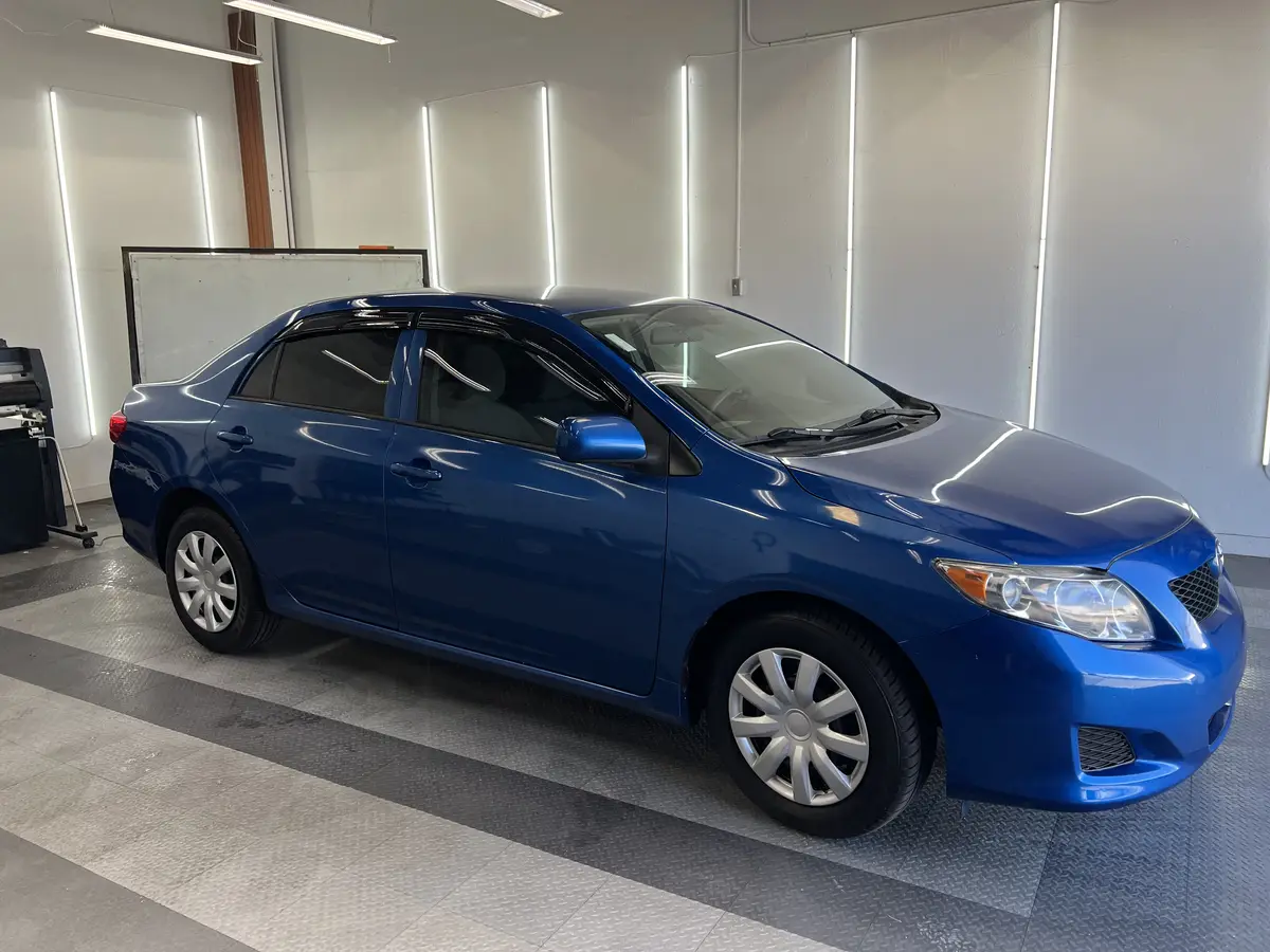Blue Toyota Corolla after Avery Dennison Encore carbon window tint (view 1)