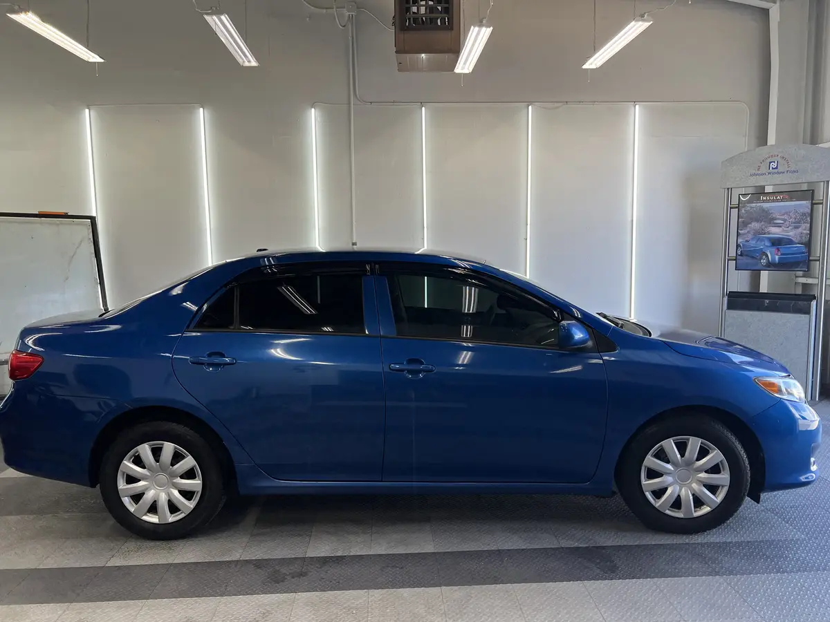 Blue Toyota Corolla after Avery Dennison Encore carbon window tint (view 2)