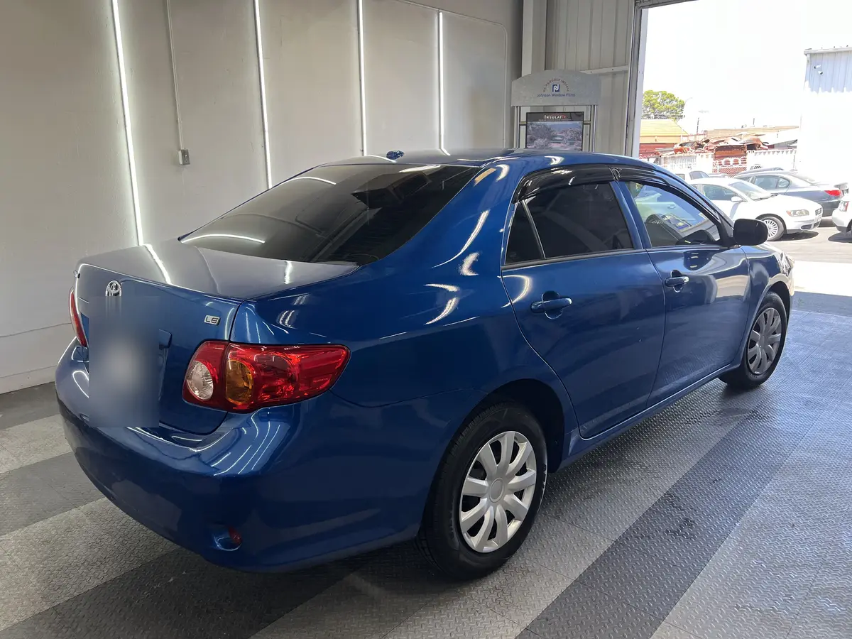 Blue Toyota Corolla after Avery Dennison Encore carbon window tint (view 3)