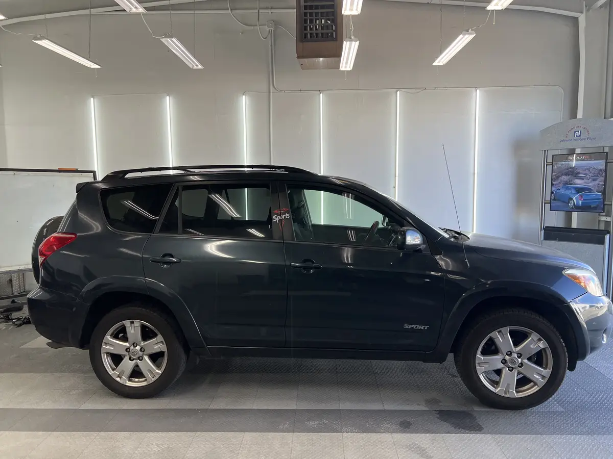 Gray Toyota RAV4 before window tinting, factory glass (view 1)