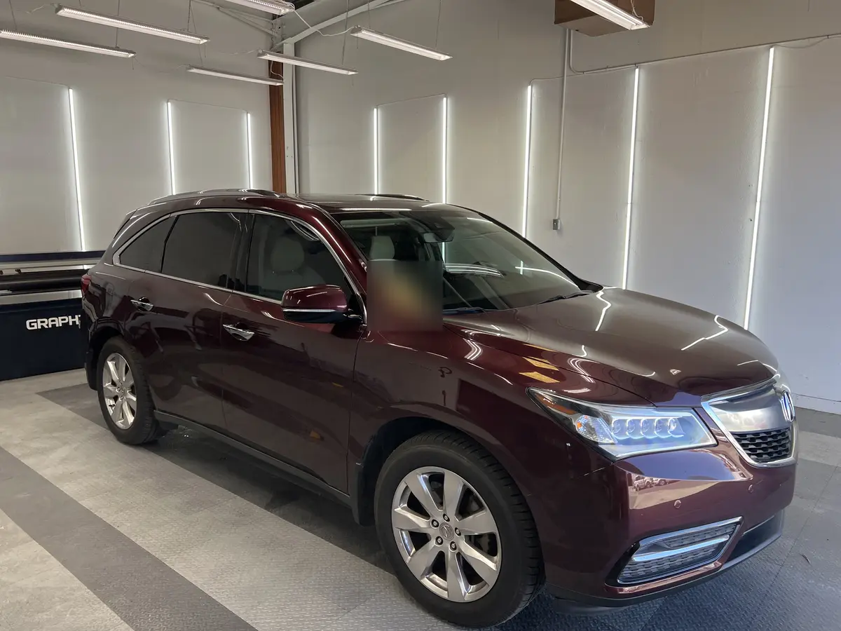 Red Acura MDX before window tinting, factory glass (view 1)
