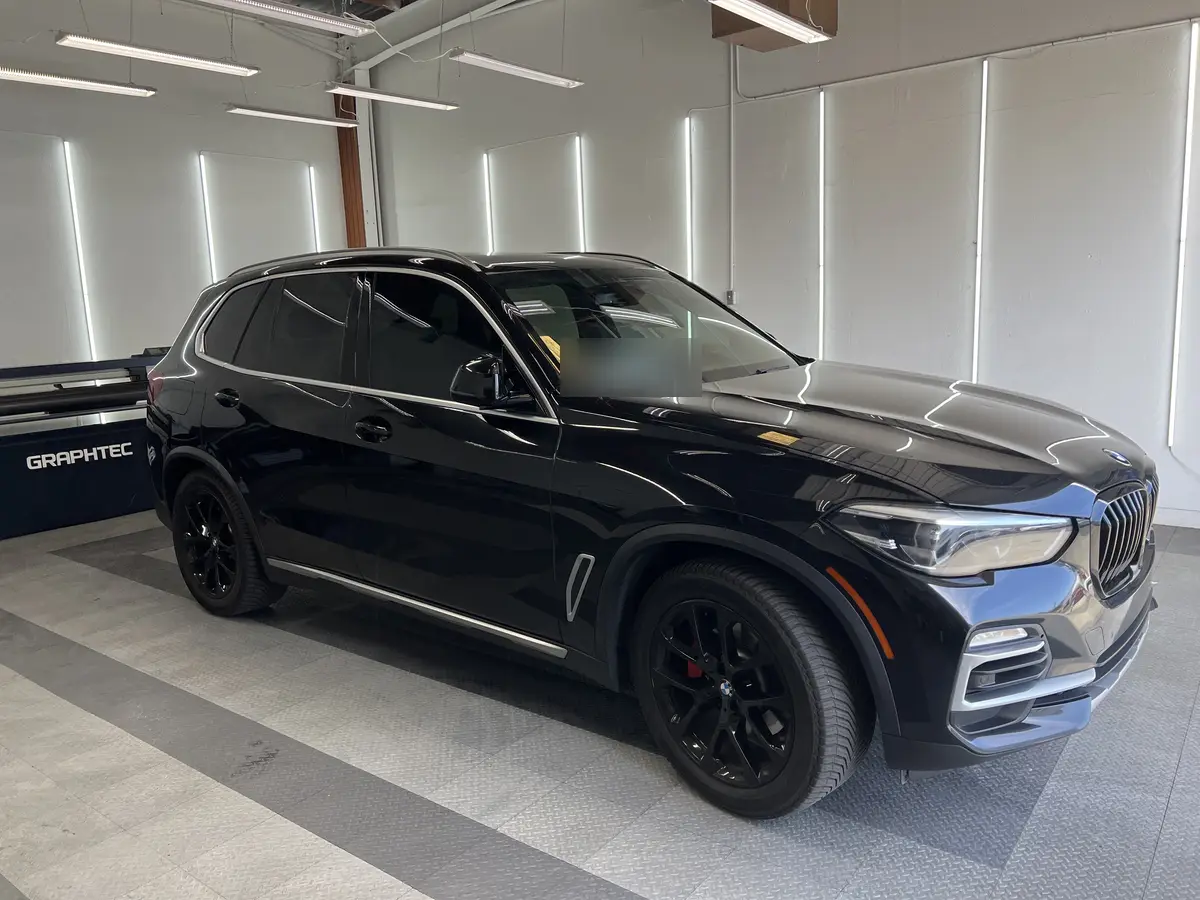 Black BMW X5 after Avery Dennison Encore carbon window tint (view 1)