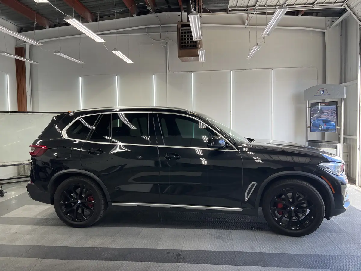 Black BMW X5 after Avery Dennison Encore carbon window tint (view 2)