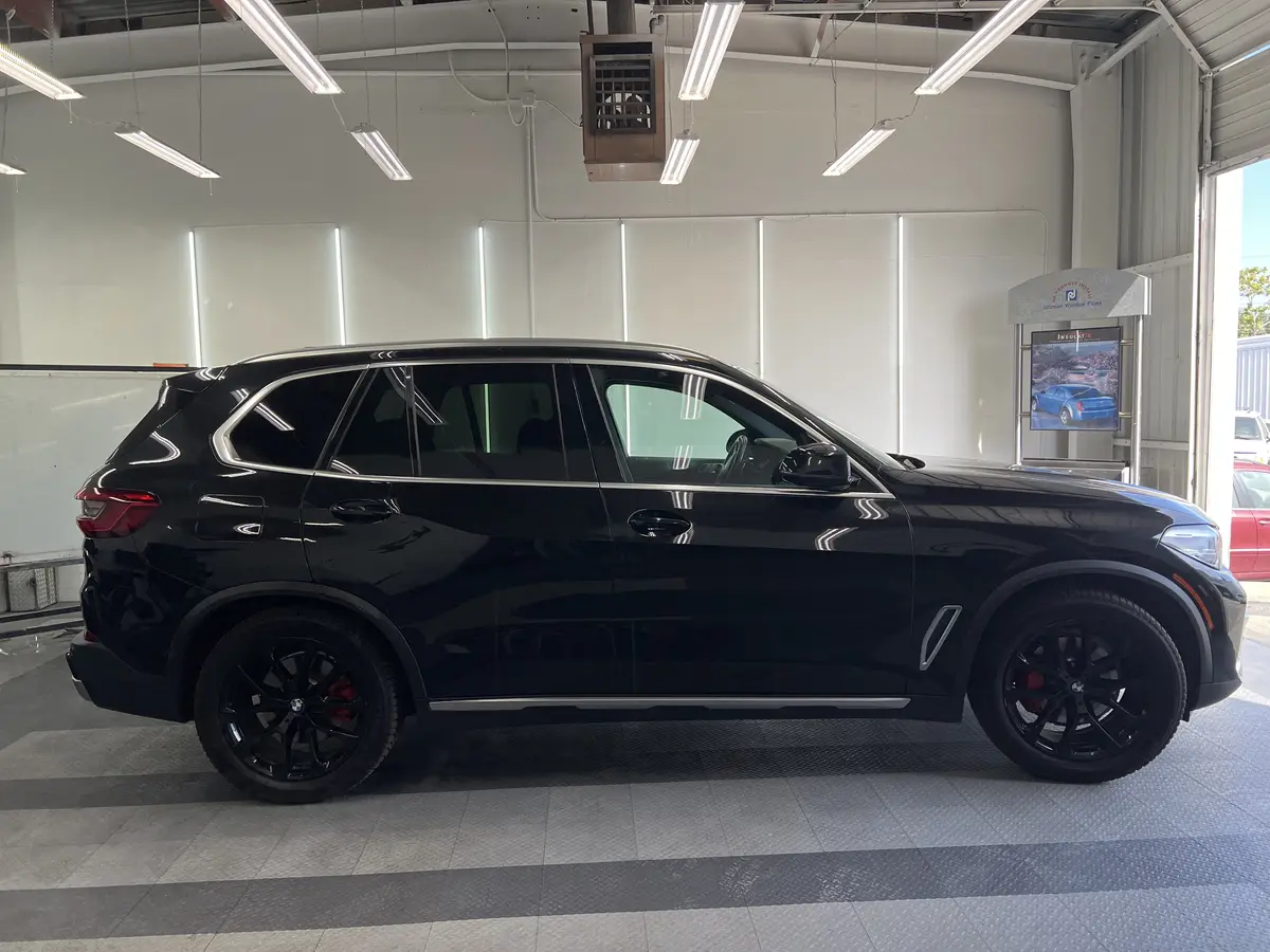 Black BMW X5 before window tinting, factory glass (view 2)