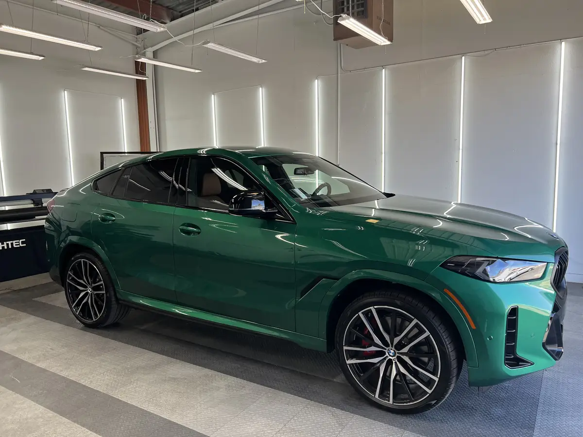 Green BMW X6 before window tinting, factory glass (view 1)