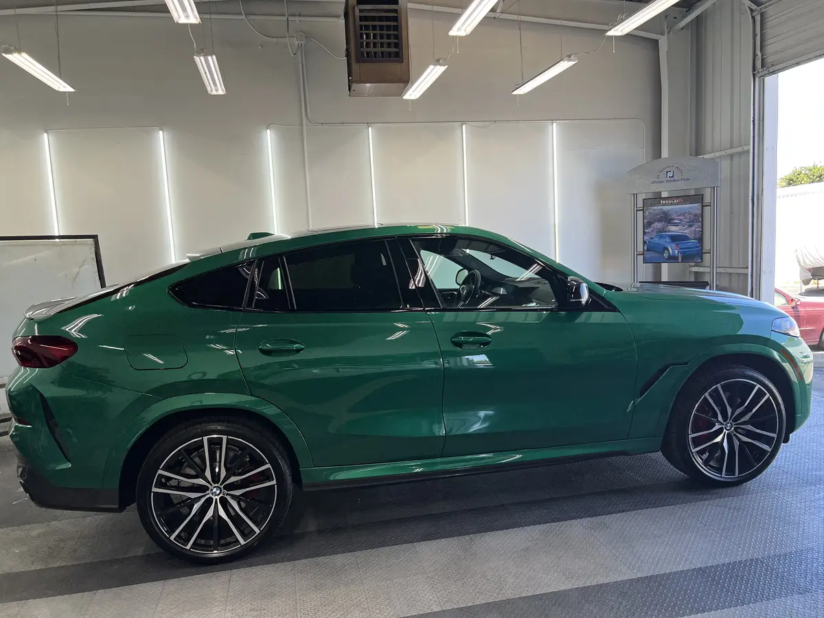 Green BMW X6 before window tinting, factory glass (view 2)