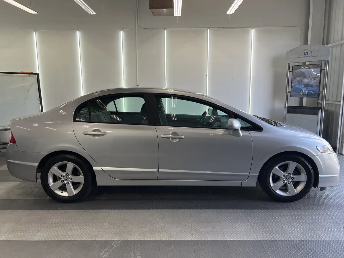 Silver Honda Civic before window tinting, factory glass (view 1)
