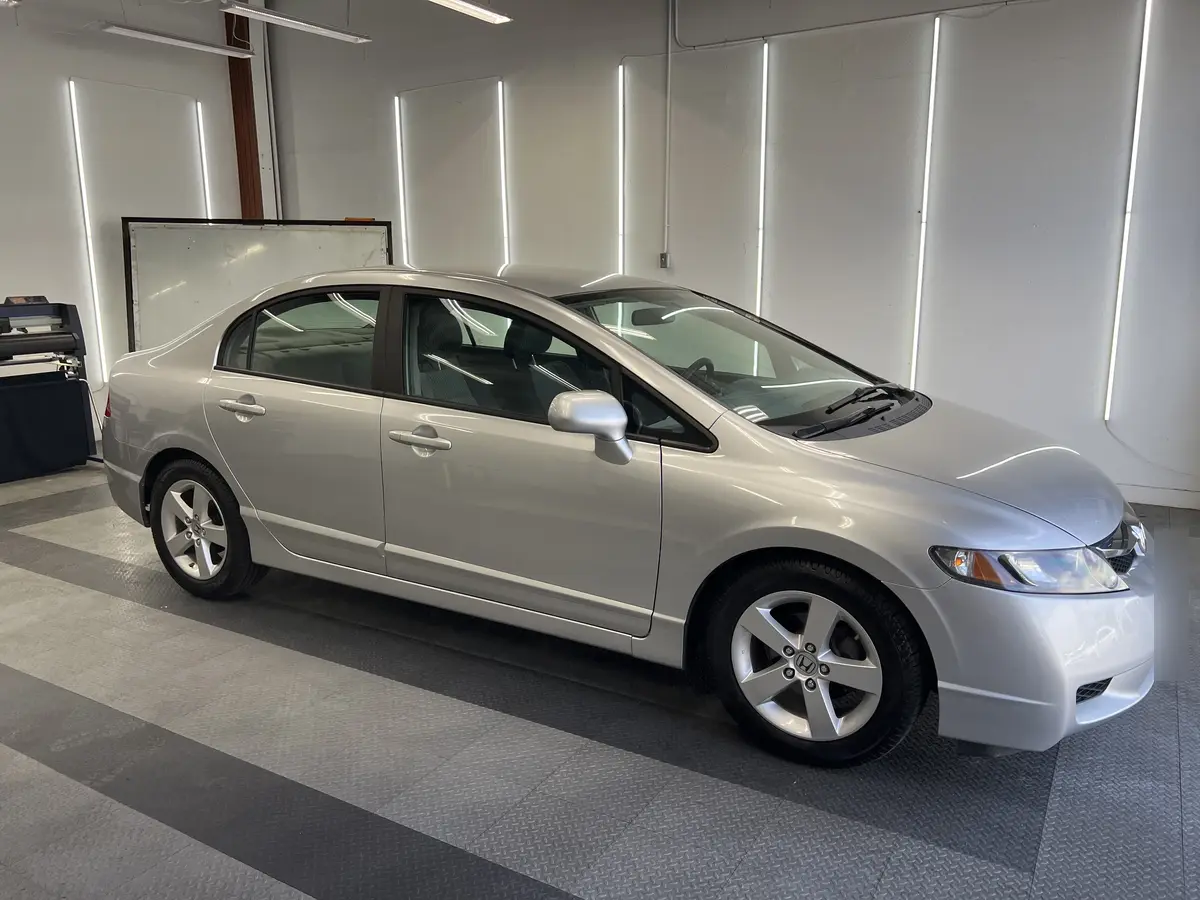 Silver Honda Civic before window tinting, factory glass (view 2)