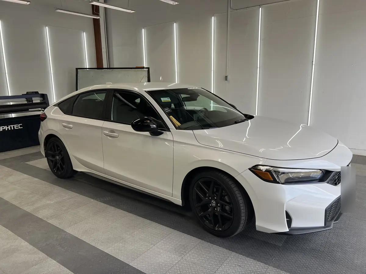 White Honda Civic before window tinting, factory glass (view 1)