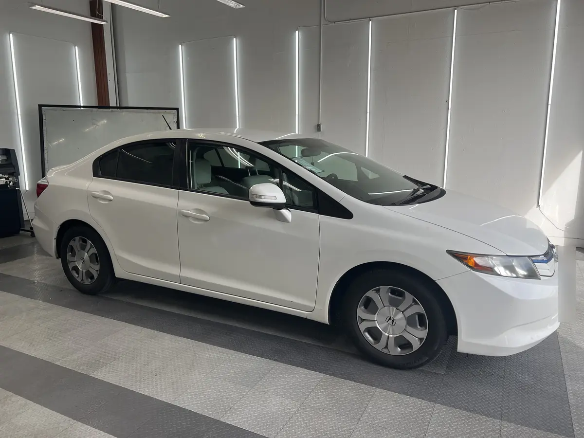 White Honda Civic before window tinting, factory glass (view 1)