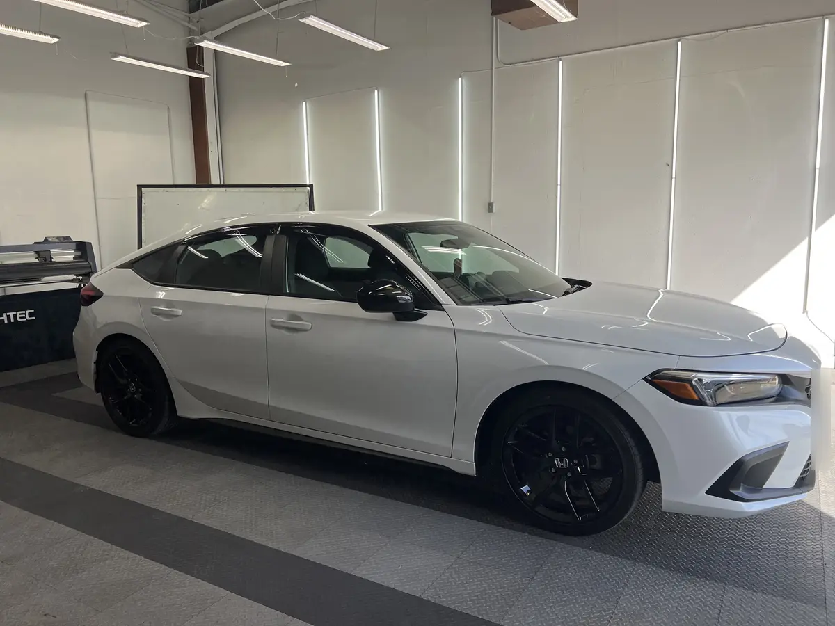 White Honda Civic before window tinting, factory glass (view 1)