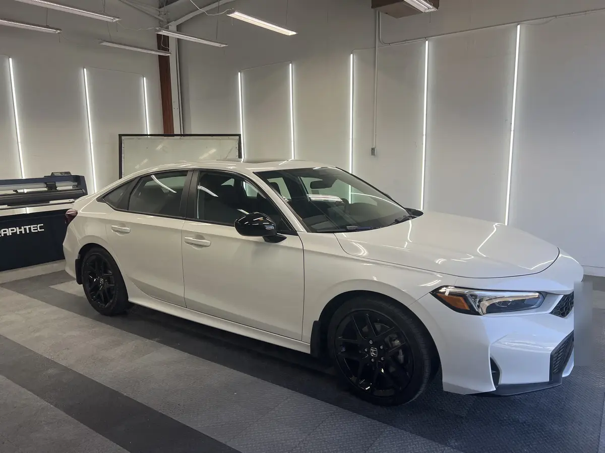 White Honda Civic before window tinting, factory glass (view 1)