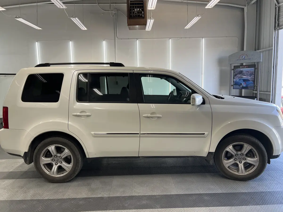 White Honda Pilot before window tinting, factory glass (view 2)