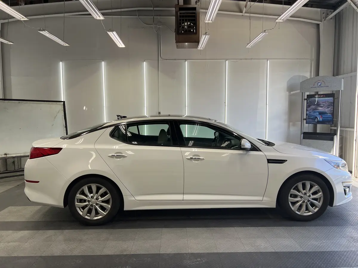 White Kia Optima before window tinting, factory glass (view 2)