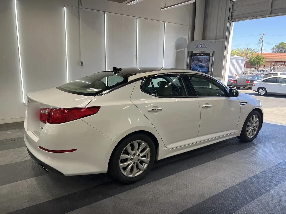 White Kia Optima before window tinting, factory glass (view 3)