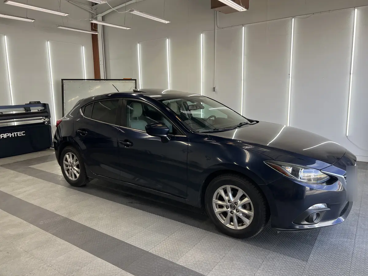 Blue Mazda Mazda3 after Avery Dennison Encore Supreme ceramic window tint (view 1)