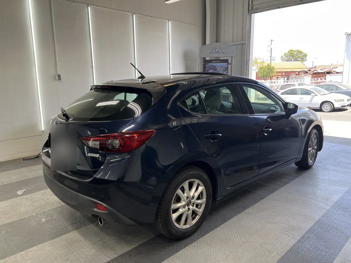 Blue Mazda Mazda3 before window tinting, factory glass (view 1)