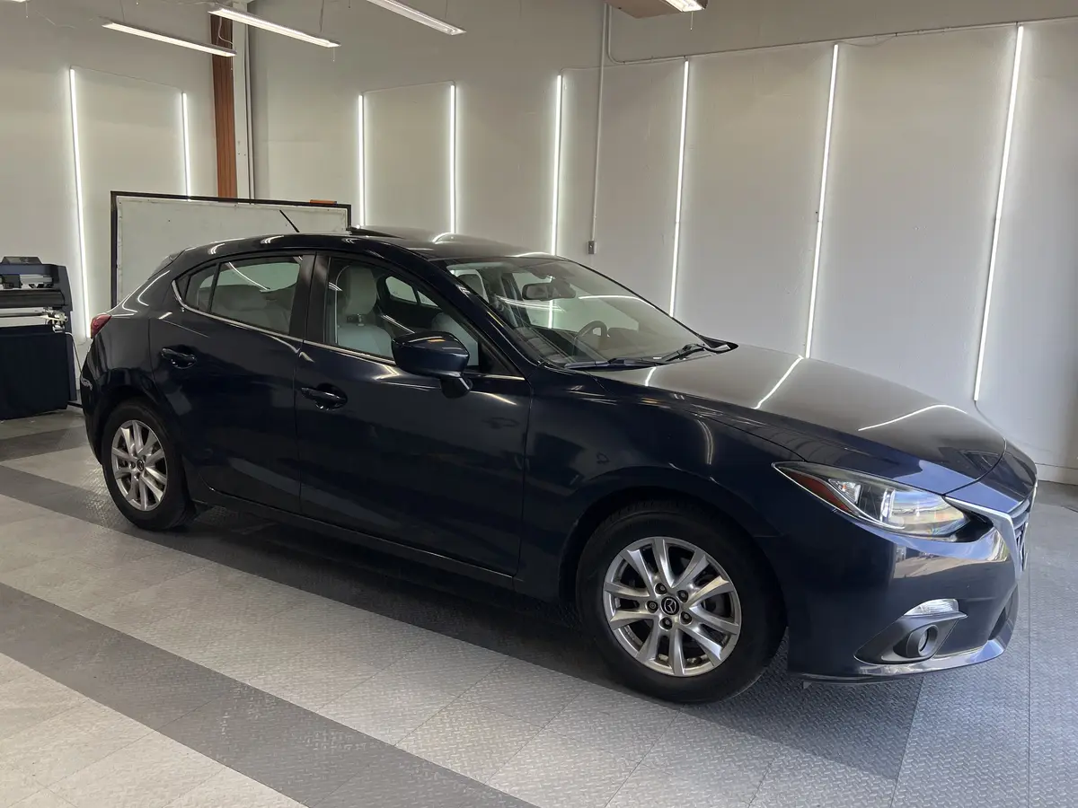 Blue Mazda Mazda3 before window tinting, factory glass (view 3)