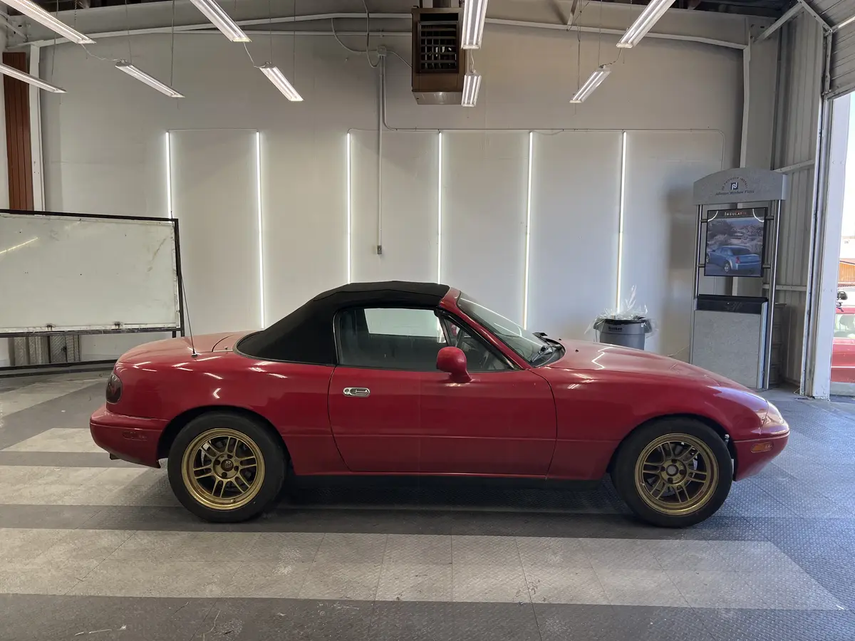 Red Mazda MX-5 Miata before window tinting, factory glass (view 2)