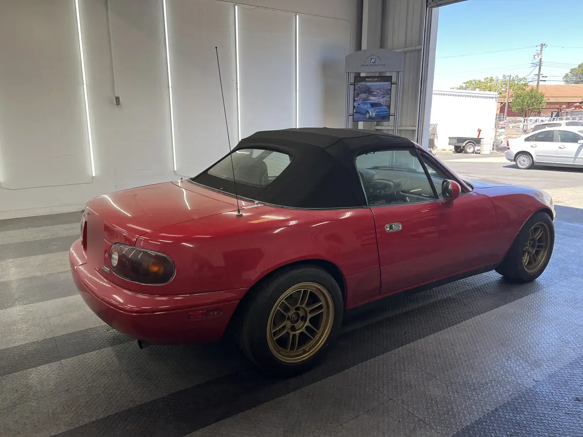 Red Mazda MX-5 Miata before window tinting, factory glass (view 3)