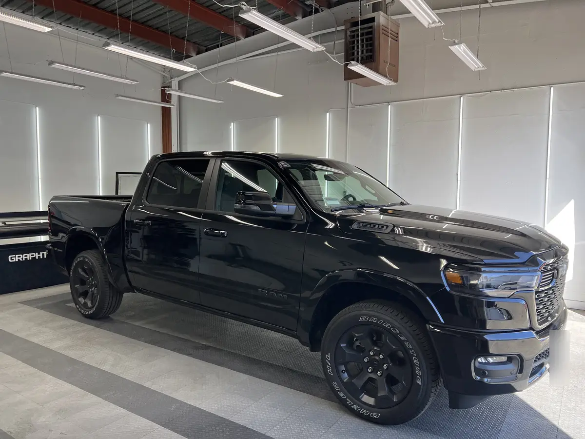 Black Ram 1500 before window tinting, factory glass (view 1)