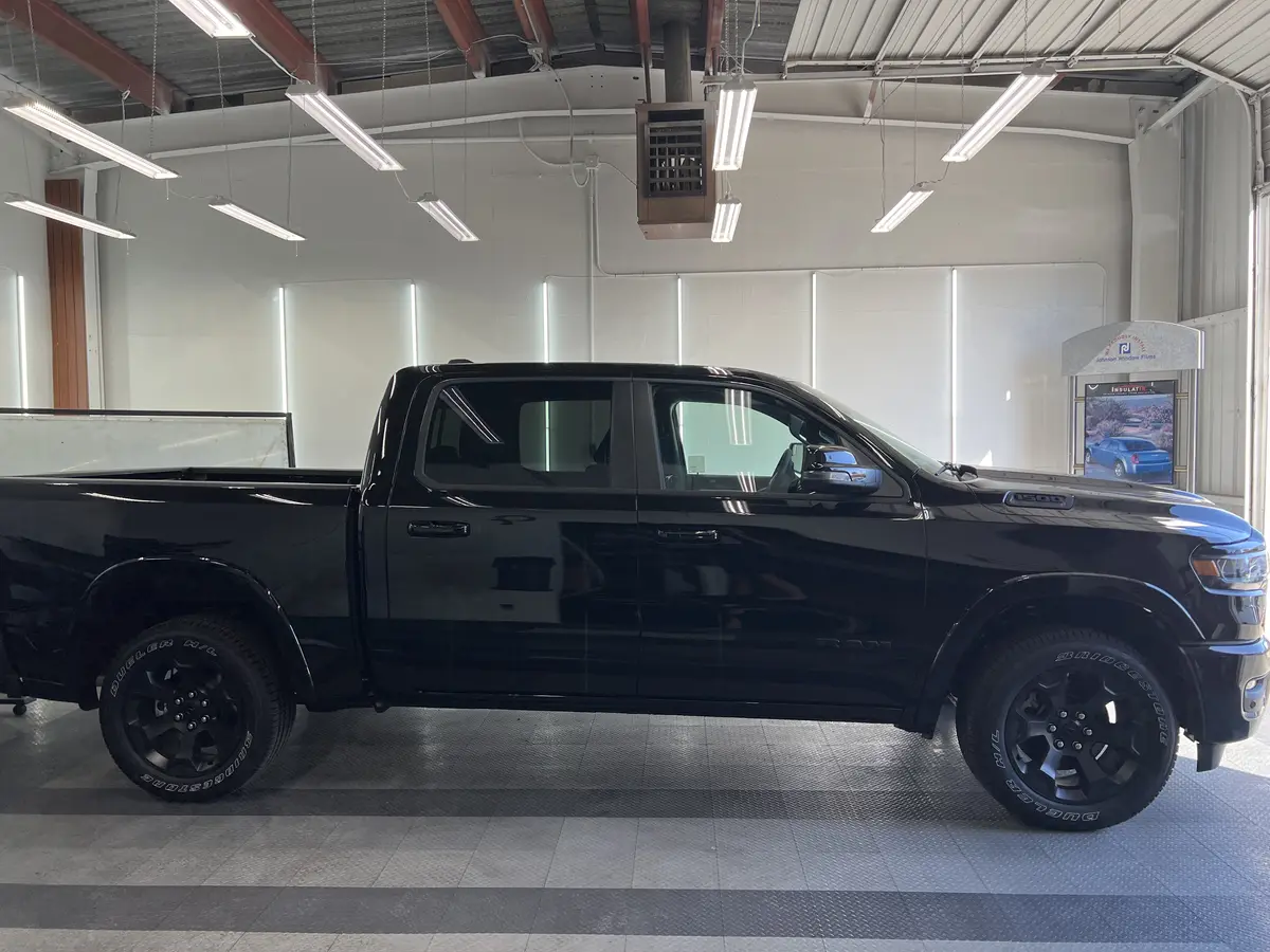 Black Ram 1500 before window tinting, factory glass (view 2)