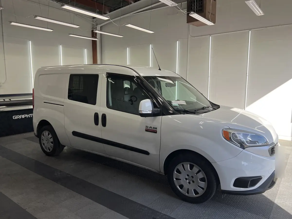 White Ram ProMaster City before window tinting, factory glass (view 1)