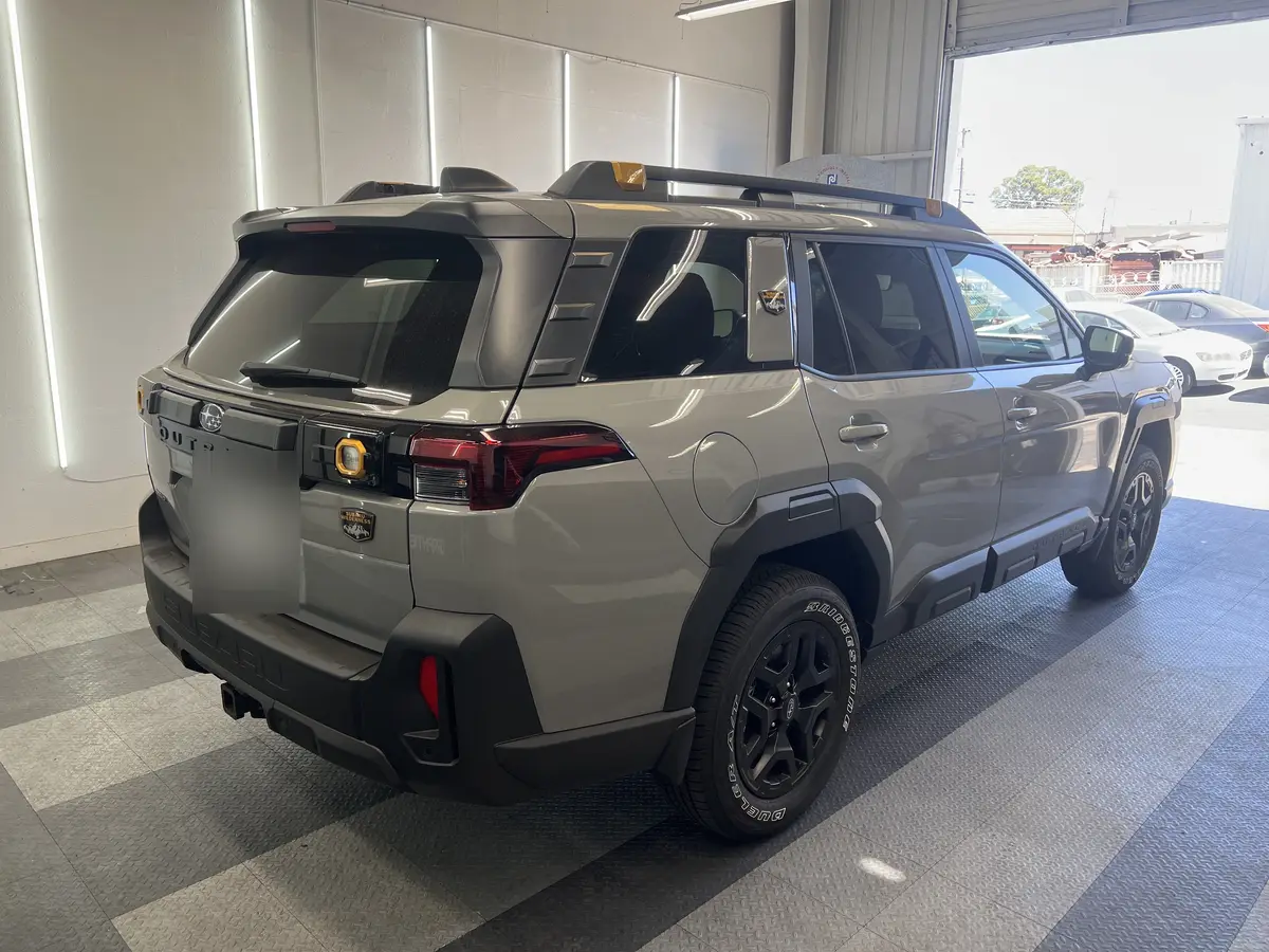 Gray Subaru Forester before window tinting, factory glass (view 1)