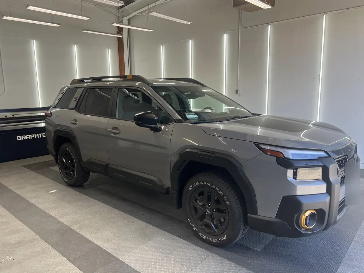 Gray Subaru Forester before window tinting, factory glass (view 2)