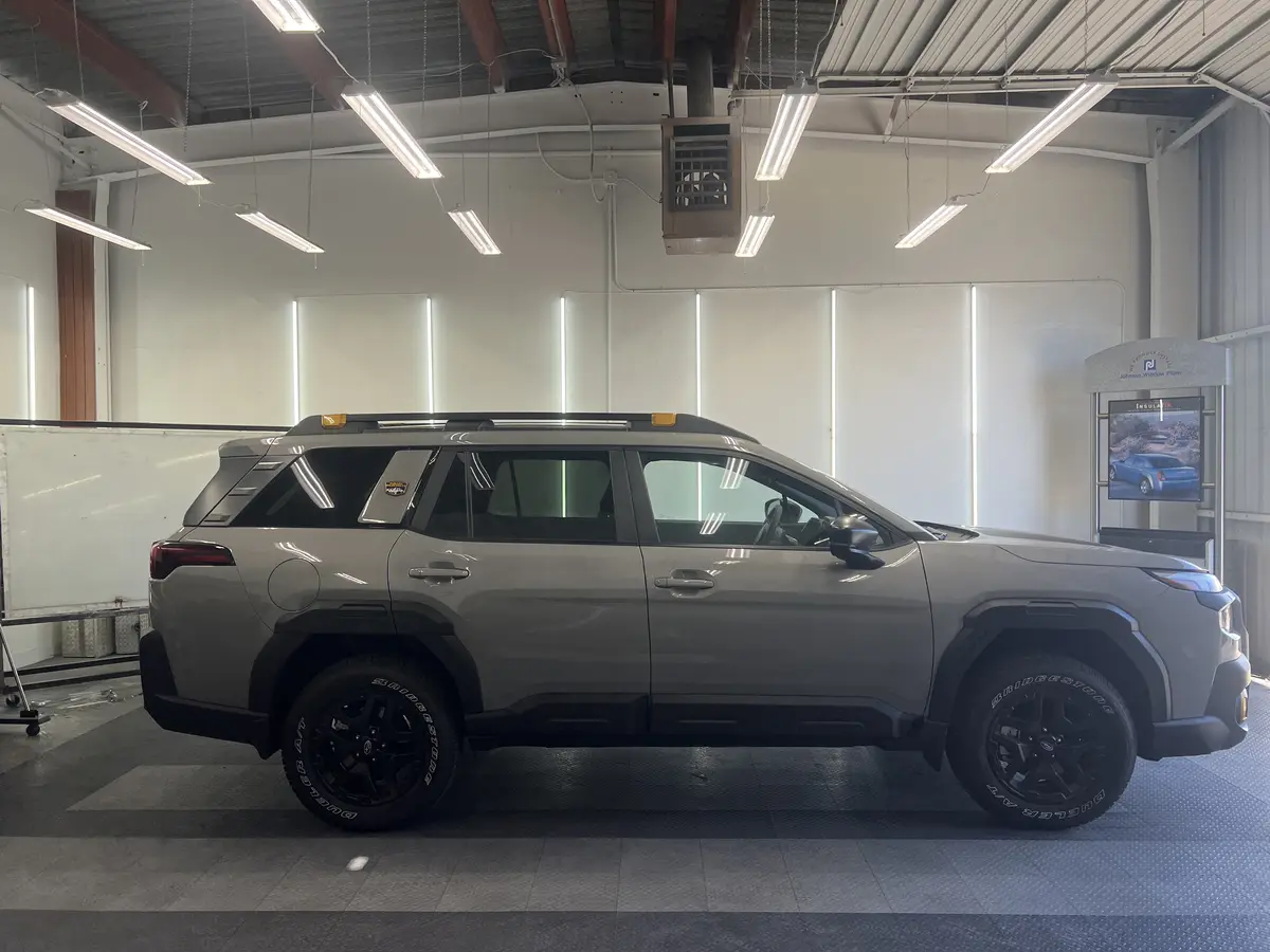 Gray Subaru Forester before window tinting, factory glass (view 3)