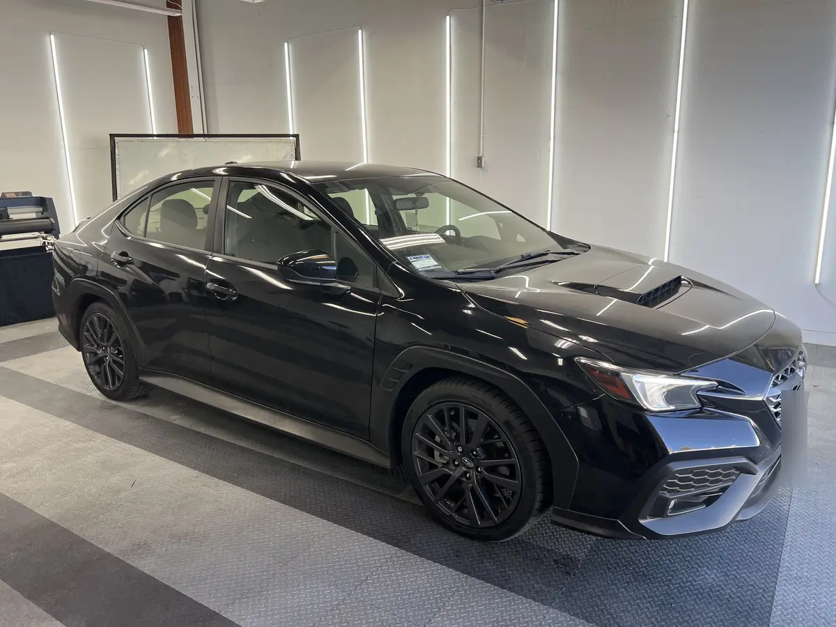 Black Subaru WRX before window tinting, factory glass (view 1)