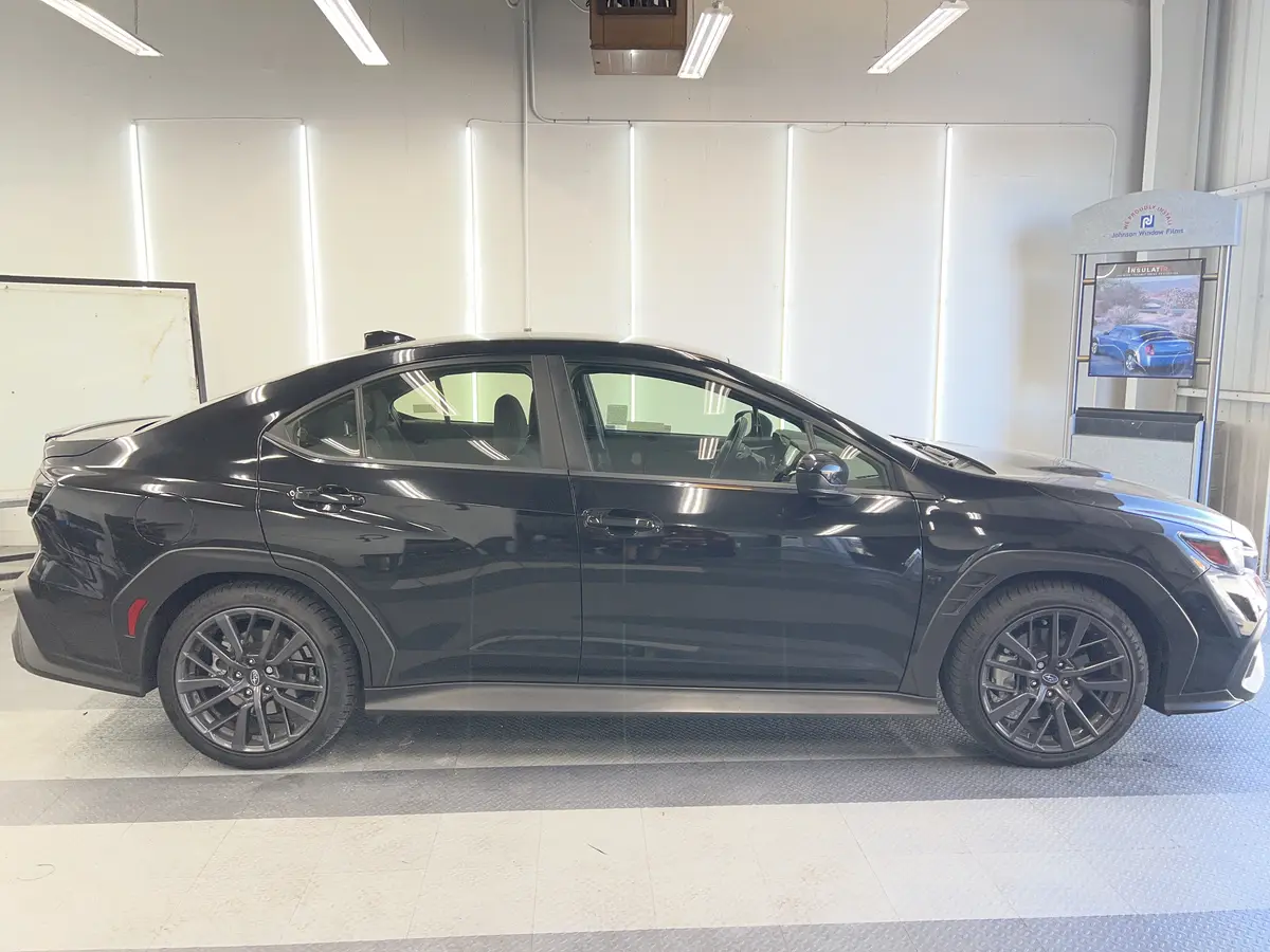 Black Subaru WRX before window tinting, factory glass (view 2)