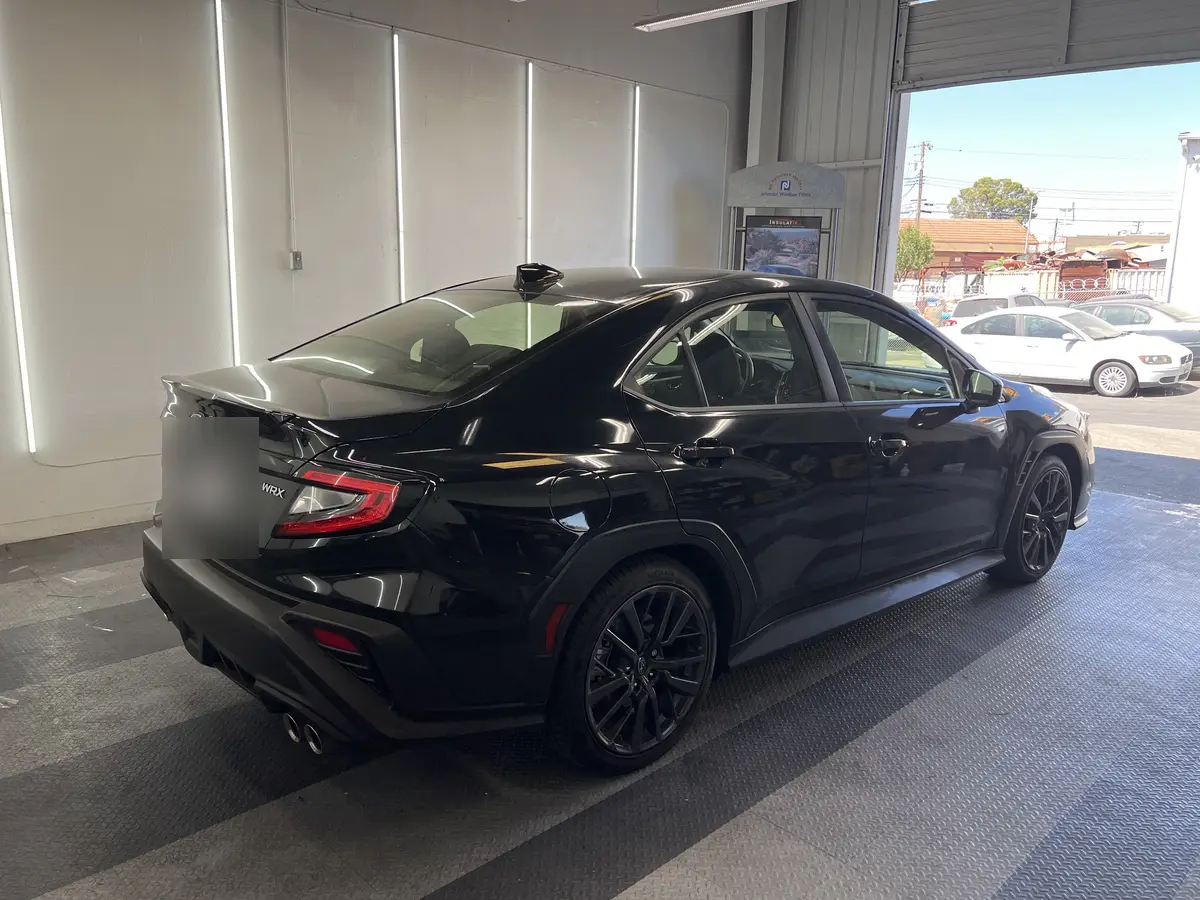 Black Subaru WRX before window tinting, factory glass (view 3)